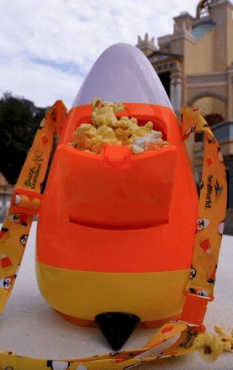 Back of SeaWorld Orlando candy corn penguin popcorn bucket filled with popcorn